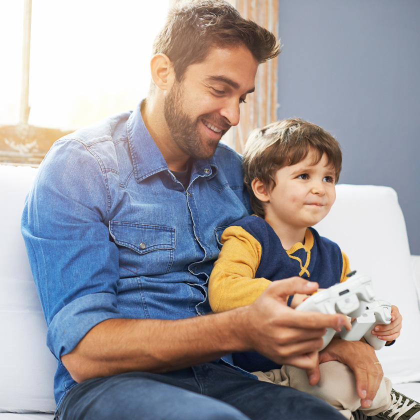 Man and his son playing a video game together